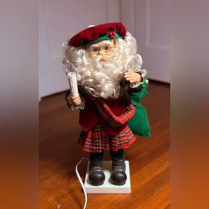 Motion-ettes Santa Clause Wearing Red Plaid Skirt Red Beret & Illuminated Candle